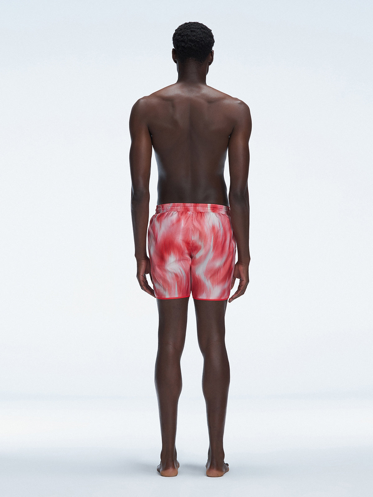 Back view of Griffin Red Sonar Swim Shorts on a model, displaying the vibrant print and functional details.
