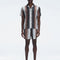 Model wearing Dominic Black Degraded Shorts with relaxed fit and button front closure.

