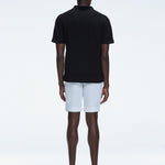 Back view of the model wearing the Atticus Black Polo T-Shirt, showcasing the slim fit and short sleeves.
