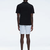 Back view of the model wearing the Atticus Black Polo T-Shirt, showcasing the slim fit and short sleeves.
