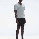 Side view of the Atticus Grey Polo T-Shirt on a model, highlighting the sleek open collar and short sleeves.
