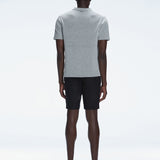 Back view of the model wearing the Atticus Grey Polo T-Shirt, showcasing the slim fit and short sleeves.
