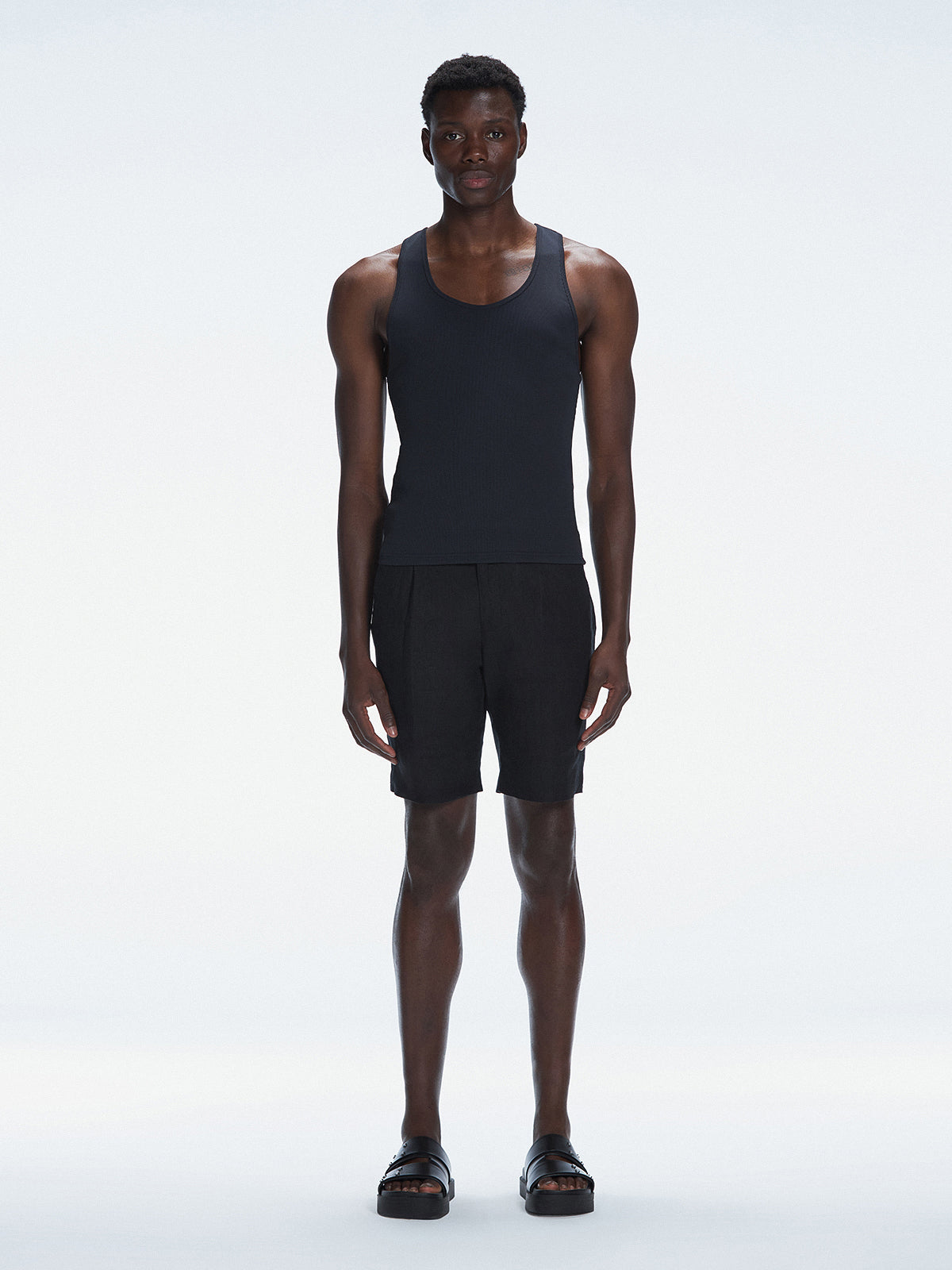 Front view of the model wearing the Phillip Black Tank Top, showing the sleek fit and comfortable cut.
