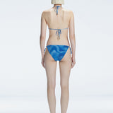 Back view of model wearing Hermione Blue Optical Bikini Bottom, highlighting the low-waist fit and sleek design.
