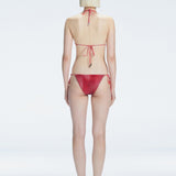Back view of model wearing Hermione Red Optical Bikini Bottom, highlighting the low-waist fit and sleek design.

