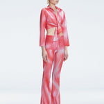 Side view of model showcasing the front tie and sleek fit of the Greta Red Sonar Top and Freya Pant
