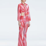 Side view of model showcasing the front tie and sleek fit of the Greta Red Sonar Top and Freya Pant
