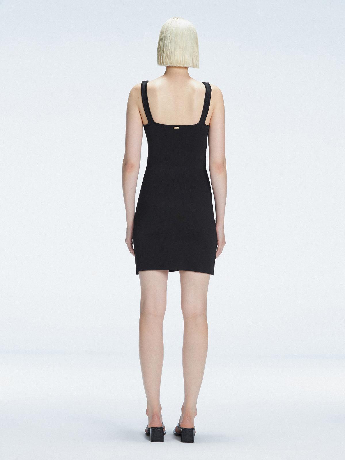 Back view of model wearing Heather Black Dress, highlighting the sleek silhouette and adjustable straps.
