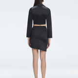 Back view of model wearing Greta Black Shirt, highlighting the elegant cropped silhouette.
