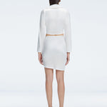 Back view of model wearing Greta White Shirt and Antonia White Skirt, highlighting the elegant cropped silhouette.
