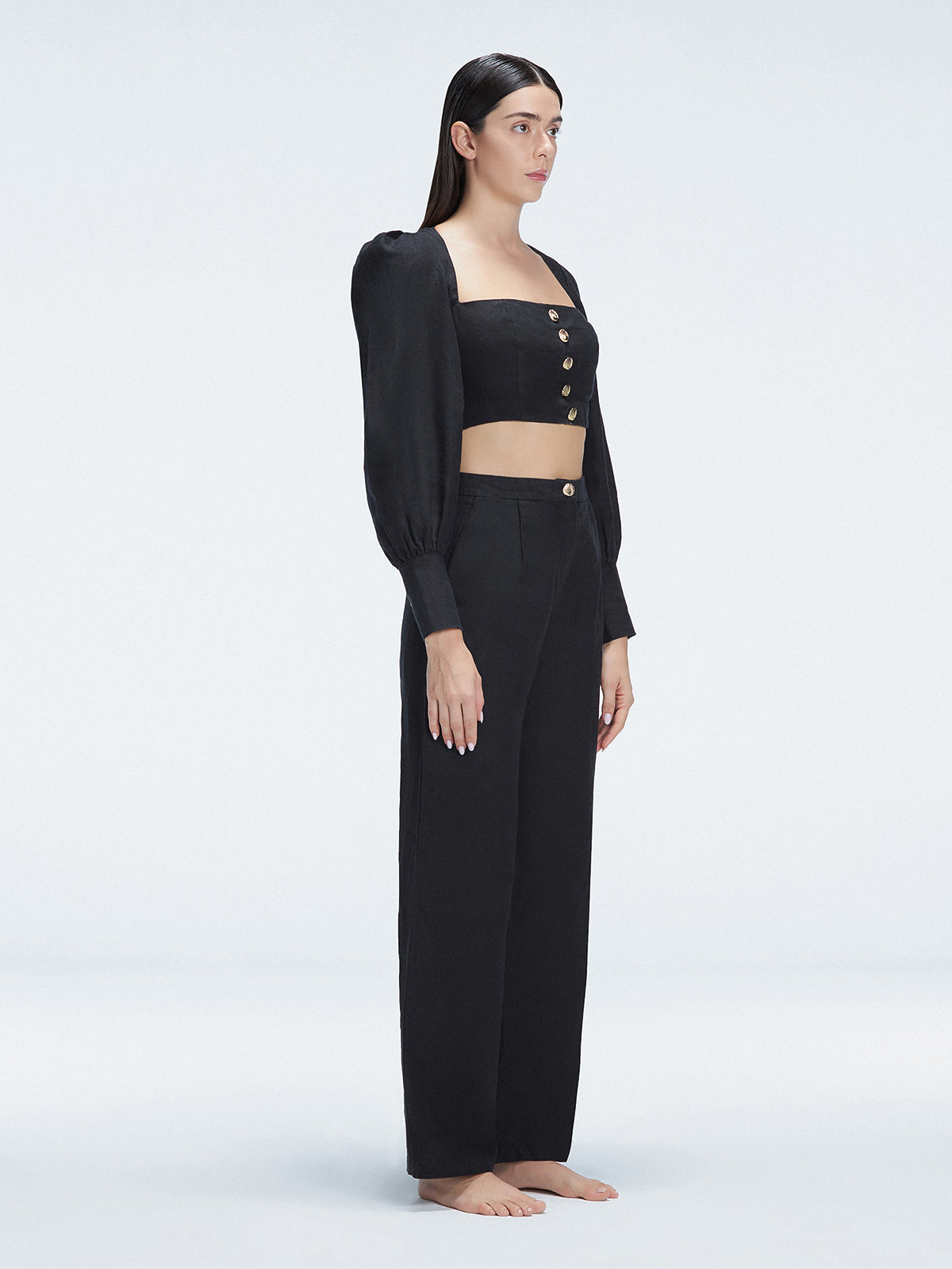 Side view of model showcasing the wide-leg design and sleek silhouette of the Valencia Black Pants.
