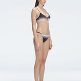 Side view of model showcasing the adjustable straps and printed fabric on the Rory Black Bikini Set .
