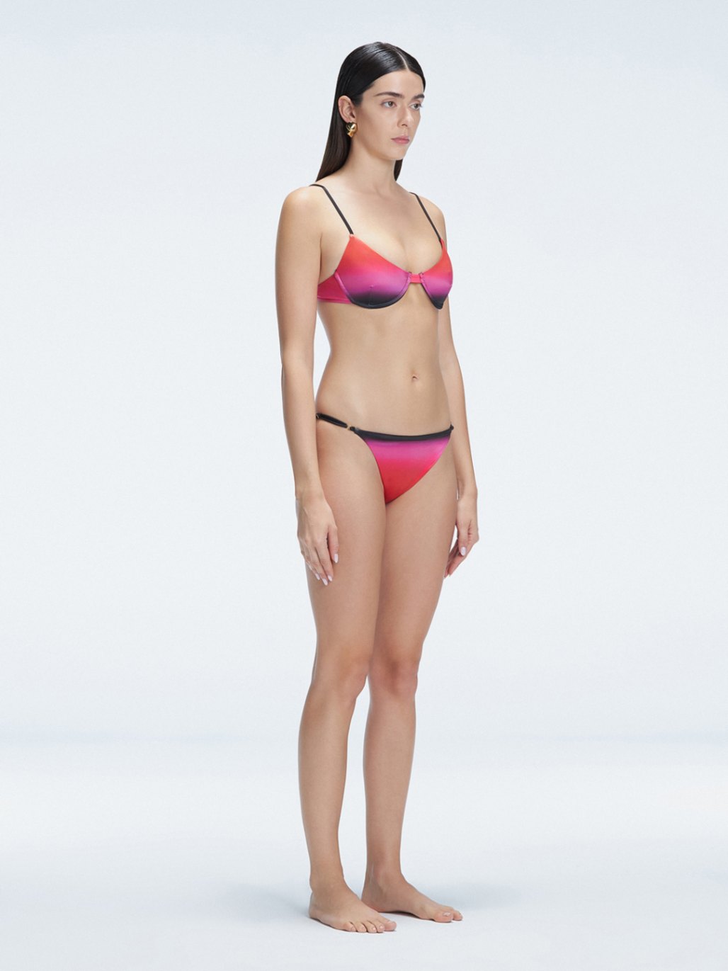 Side view of model showcasing the adjustable straps and printed fabric on the Rory Pink Bikini Set .
