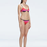 Side view of model showcasing the adjustable straps and printed fabric on the Rory Pink Bikini Top.
