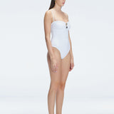 "Side view of the removable straps and ruched chest detail on the Zephyrine White Swimsuit, emphasizing its versatility."
