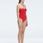 "Side view of the removable straps and ruched chest detail on the Zephyrine Red Swimsuit, emphasizing its versatility."
