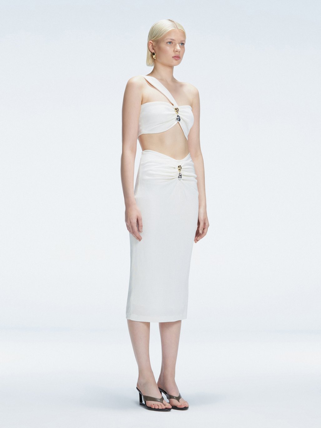 Side view of model showcasing the one-shoulder design and ruched front detail on the Lane White Top.
