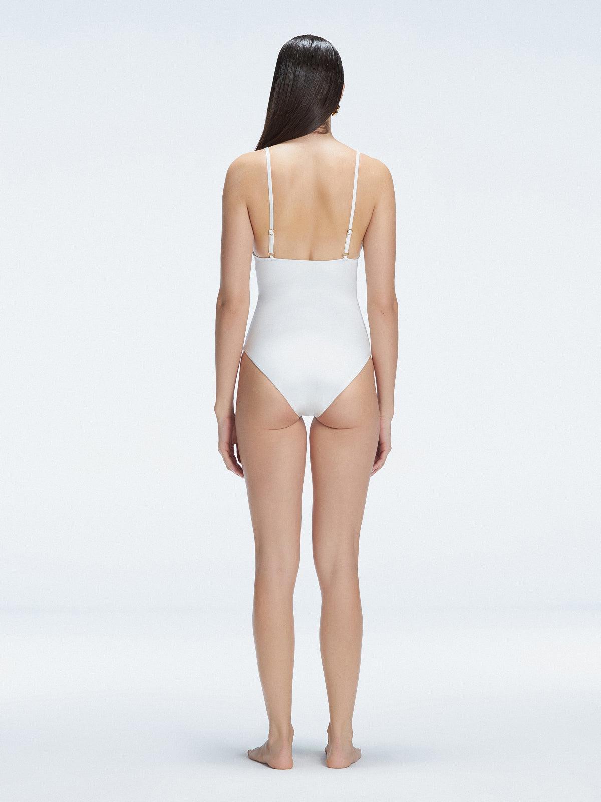 Back view of model wearing Marina Degraded White One Piece swimsuit, featuring accessory details on straps and open back design.
