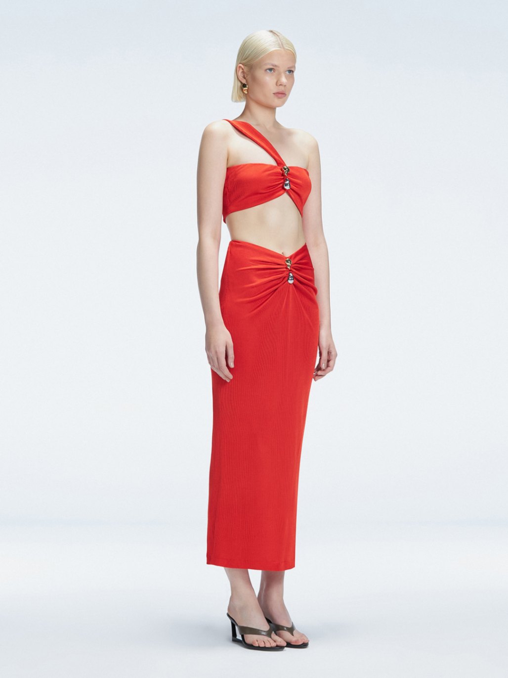 Side view of model showcasing the ruched front and sleek silhouette of the Lane Top and Esmeralda Red Midi Skirt.
