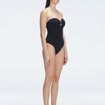 "Side view of the removable straps and ruched chest detail on the Zephyrine Black Swimsuit, emphasizing its versatility."
