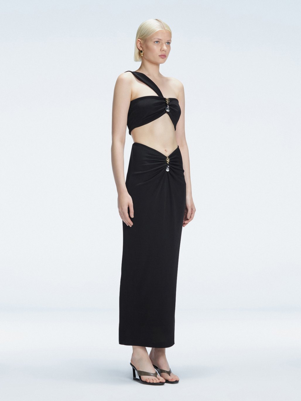 Side view of model showcasing the one-shoulder design and ruched front detail on the Lane Black Top.
