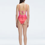 "Model showing the back of the Emma Gradient Swimsuit, highlighting the sleek fit and moderate coverage."
