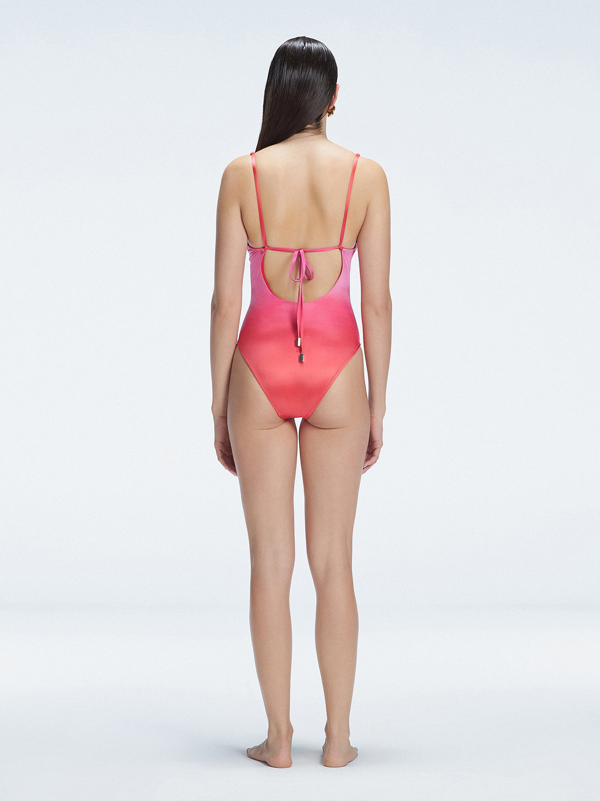 "Model showing the back of the Emma Gradient Swimsuit, highlighting the sleek fit and moderate coverage."
