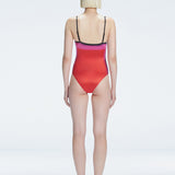 Back view of model wearing Camilla Pink Optical Swimsuit, highlighting the sleek fit and moderate coverage.
