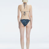 Back view of model wearing Hermione Black Optical Bikini Top, highlighting the adjustable back ties and sleek fit.
