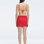 Back view of model wearing Siena Red Mini Skirt, highlighting the two-layered structure and flattering fit.
