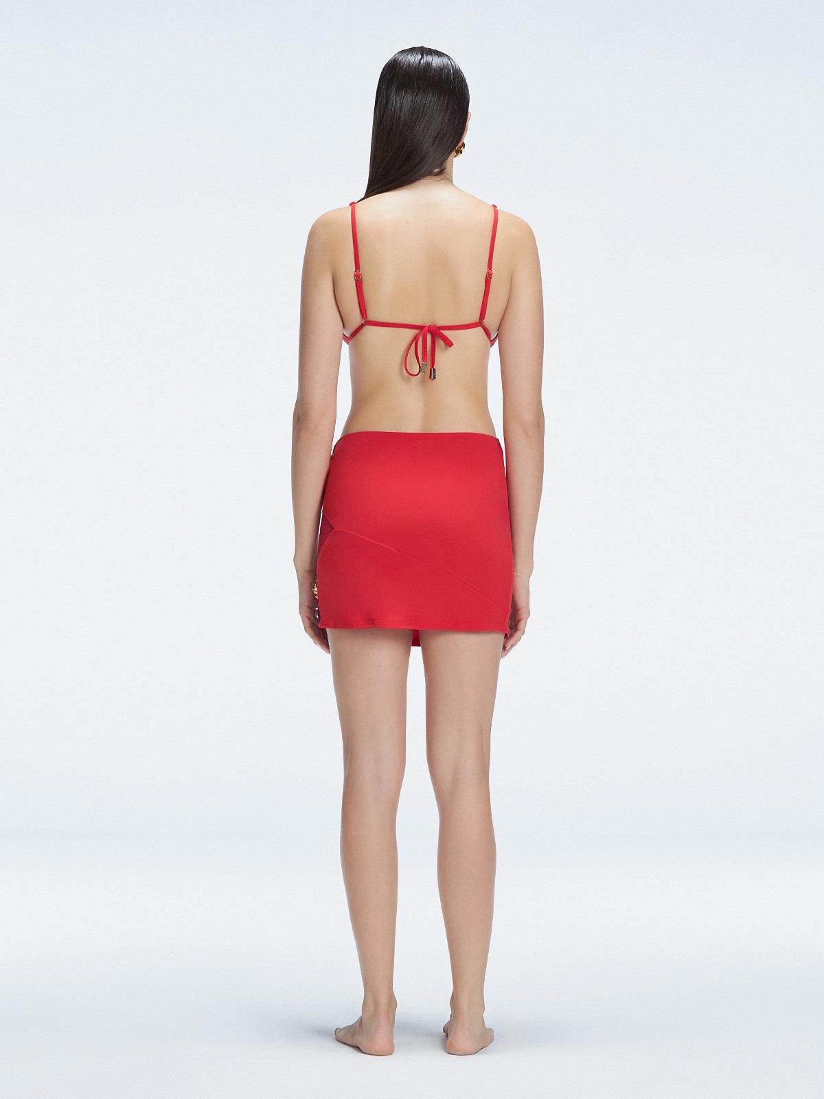 Back view of model wearing Siena Red Mini Skirt, highlighting the two-layered structure and flattering fit.
