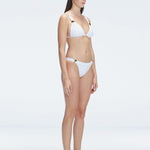"Side view  of the buckle detailing on the Zella White Bikini Bottom, emphasizing the sleek, trendy design."
