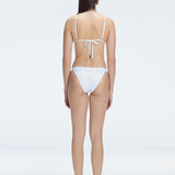 "Back view of the buckle straps and triangle neck design on the Zella White Bikini Set, emphasizing the fresh and trendy style."
