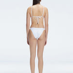 "Back view of the buckle and low waist design on the Zella White Bikini Bottom, emphasizing the fresh and trendy style."
