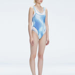 Side view of model showcasing the printed tulle and scoop neck on the Calista Blue Swimsuit.
