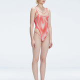 Side view of model showcasing the printed tulle and scoop neck on the Calista Red Swimsuit.
