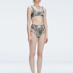 Side view of model showcasing the printed tulle and sleek high-waist fit on the Rosalind Black Bikini Set.
