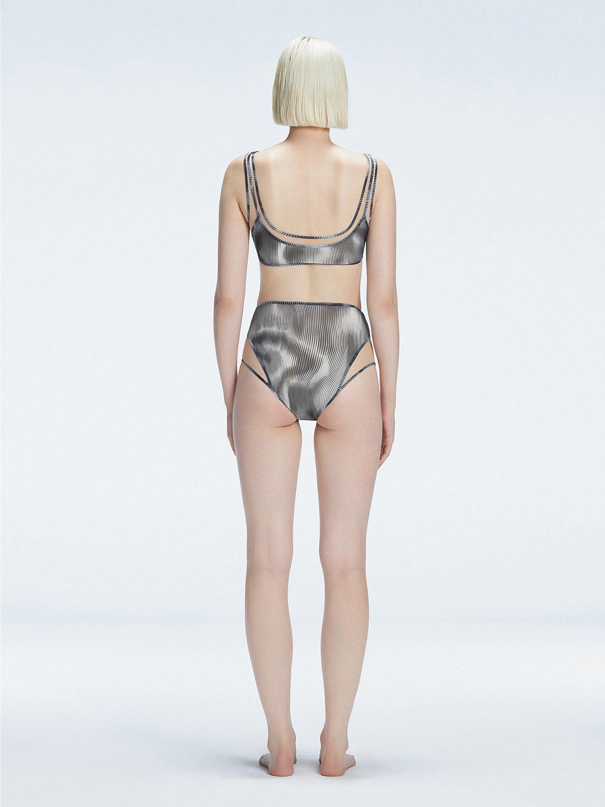 Back view of model wearing Rosalind Black Optical Bikini Top, highlighting the two-layered design and sleek fit.
