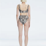 Back view of model wearing Rosalind Black Optical Bikini Set, highlighting the high-waisted fit and full coverage.
