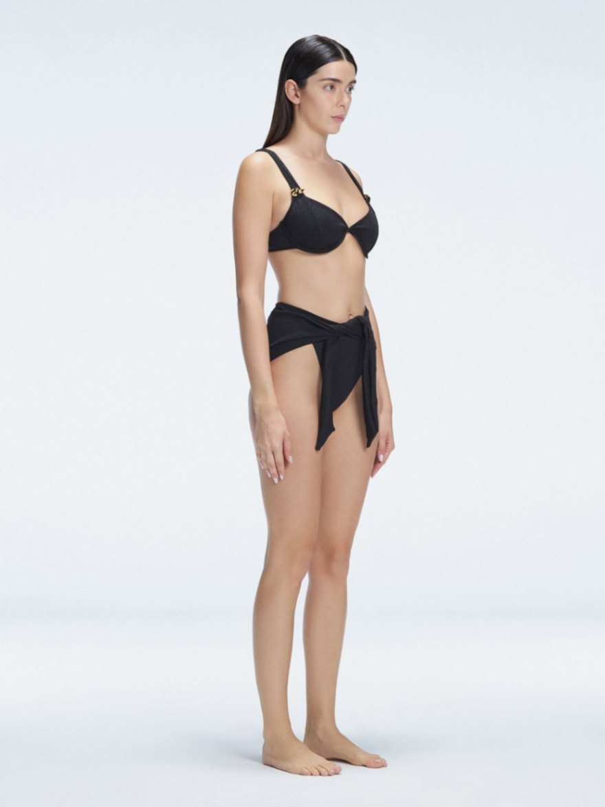 "Side view of the underwired V-neck and twist-front detail on the Madelyn Black Bikini Top and Dylan Bikini Bottom, emphasizing its elegant design."
