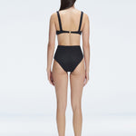 "Model showcasing the back of the Dylan Black Bikini Bottom, emphasizing the comfortable fit and moderate coverage."
