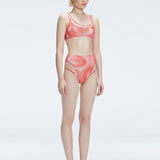 Side view of model showcasing the printed tulle and sleek high-waist fit on the Rosalind Red Bikini Set.
