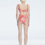 Back view of model wearing Rosalind Red Optical Bikini Bottom, highlighting the high-waisted fit and full coverage.
