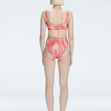 Back view of model wearing Rosalind Red Optical Bikini Bottom, highlighting the high-waisted fit and full coverage.
