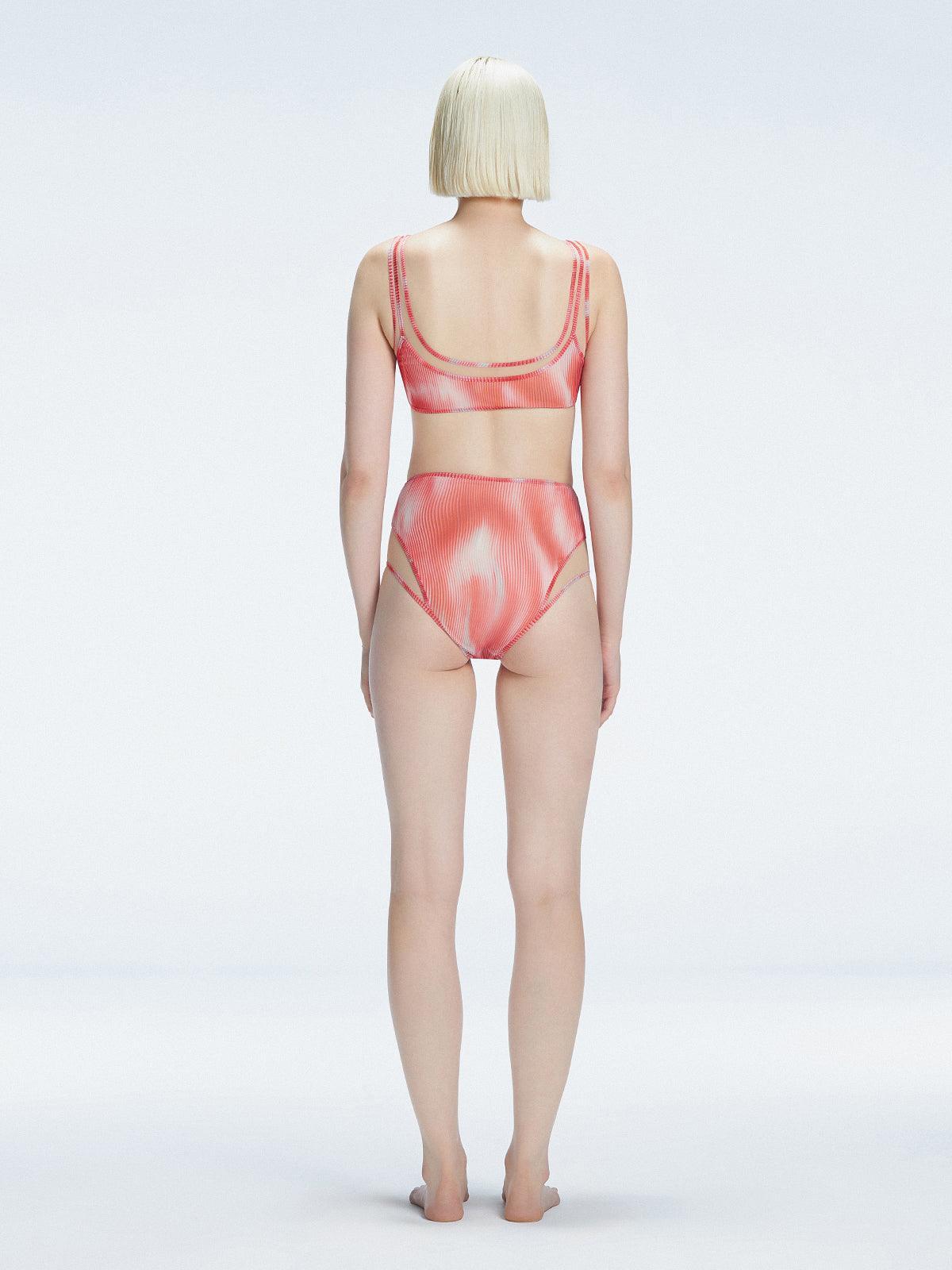 Back view of model wearing Rosalind Red Optical Bikini Bottom, highlighting the high-waisted fit and full coverage.
