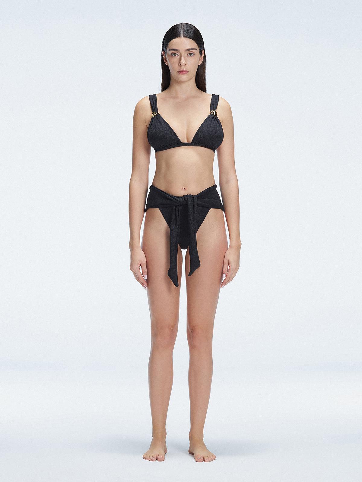 "Model wearing the Zella Shiny Black Bikini Bottom from the front view , featuring moderate coverage and a low waist fit."
