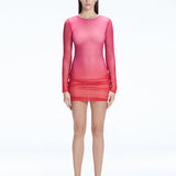 Model showcasing the Sylvie Pink Sonar Dress, highlighting its elegant long sleeves and draped skirt