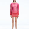 Model showcasing the Sylvie Pink Sonar Dress, highlighting its elegant long sleeves and draped skirt