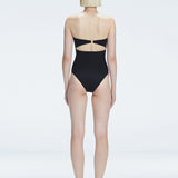 Back view of model wearing Ursula Black One Piece swimsuit, highlighting the sleek strapless silhouette.
