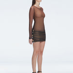 Side view of a model in the Sylvie Accessorized Mini Dress, demonstrating its elegant fit and buckle details.